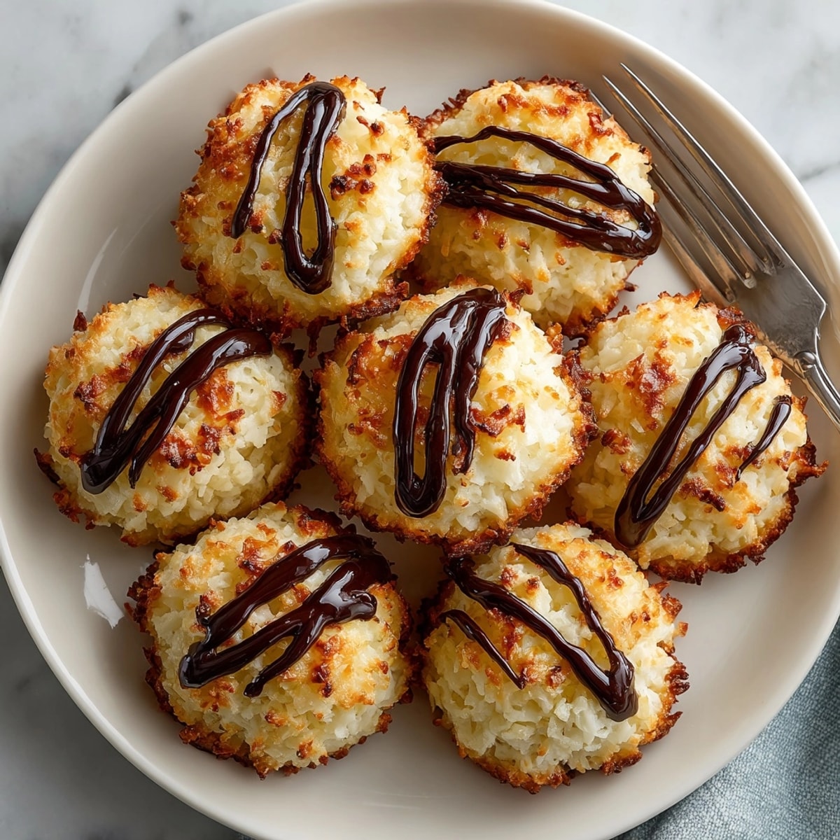 Homemade Coconut Macaroon Cookies piled on a plate, a simple yet delicious gluten-free dessert option.