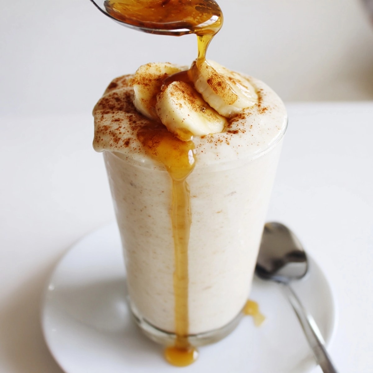 Delicious Honey Banana Smoothie, freshly blended, a creamy, golden-hued healthy drink.