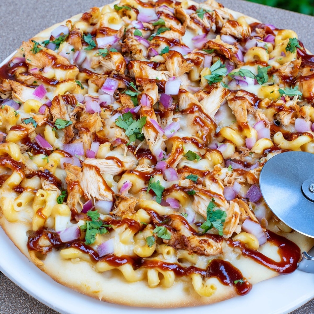 Homemade Mac and Cheese BBQ Chicken Pizza sizzling hot, ready for a cheesy dinner.