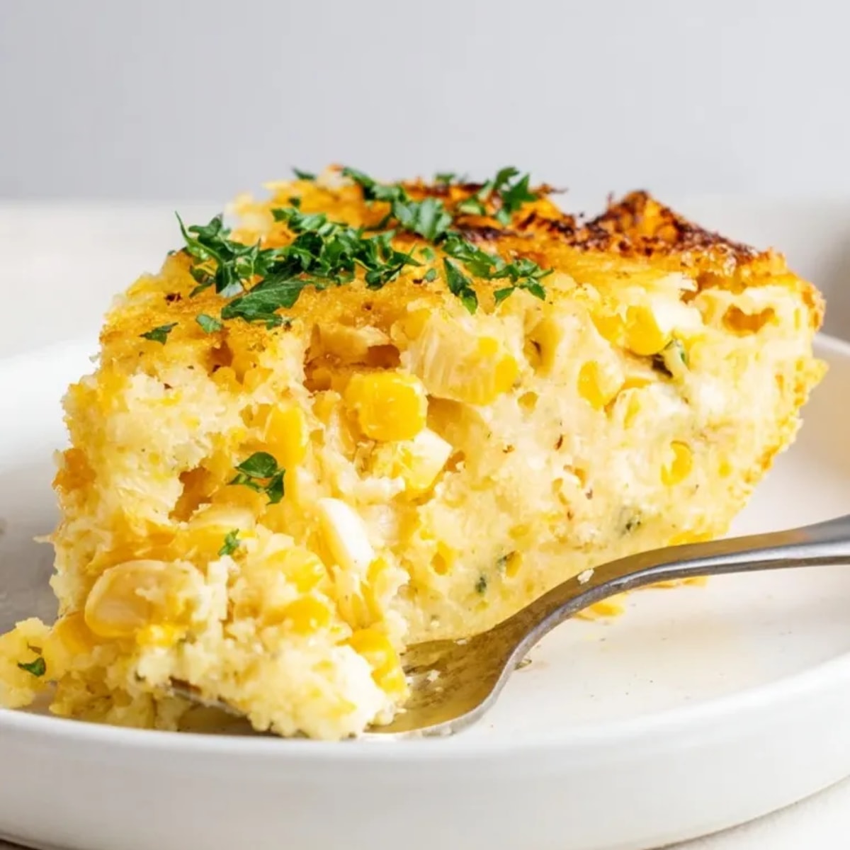Golden Garlic Parmesan Sweet Corn Bake bubbling hot, creamy comfort food goodness.