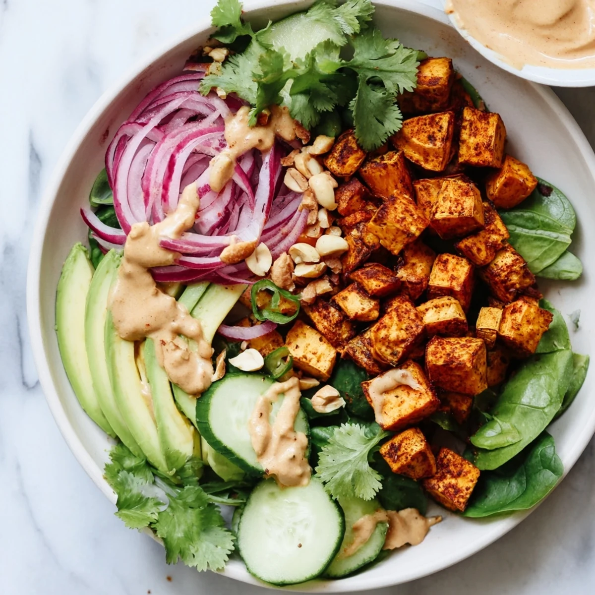 Golden roasted sweet potatoes in a Spiced Peanut Sweet Potato & Radicchio Salad Bowl, ready to eat.