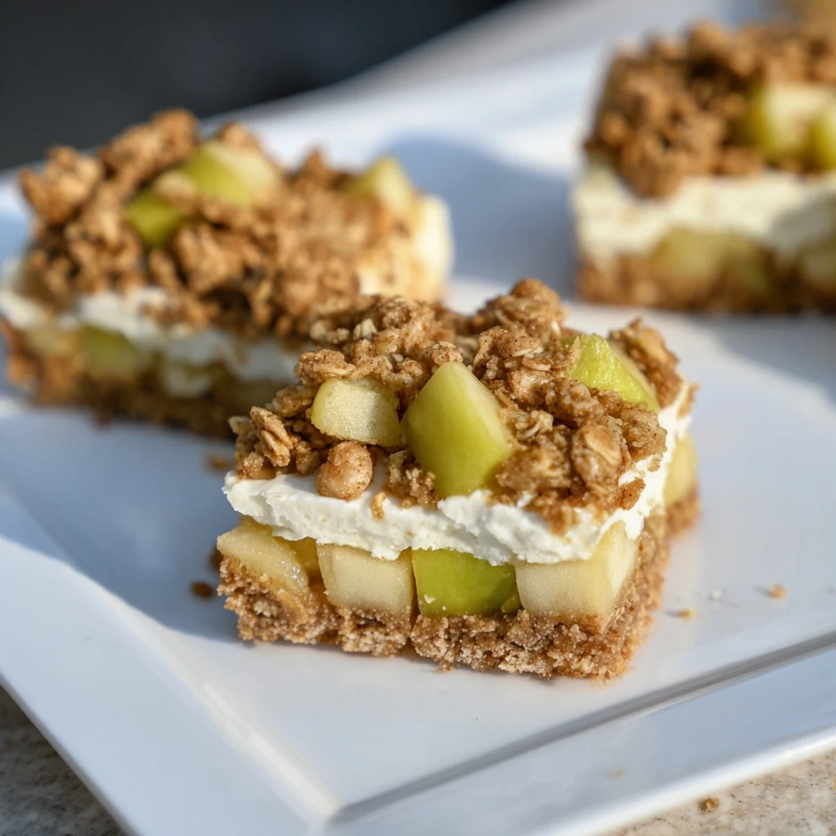 Golden-brown Apple Crisp Cheesecake Bars, featuring a creamy cheesecake filling and crunchy topping.