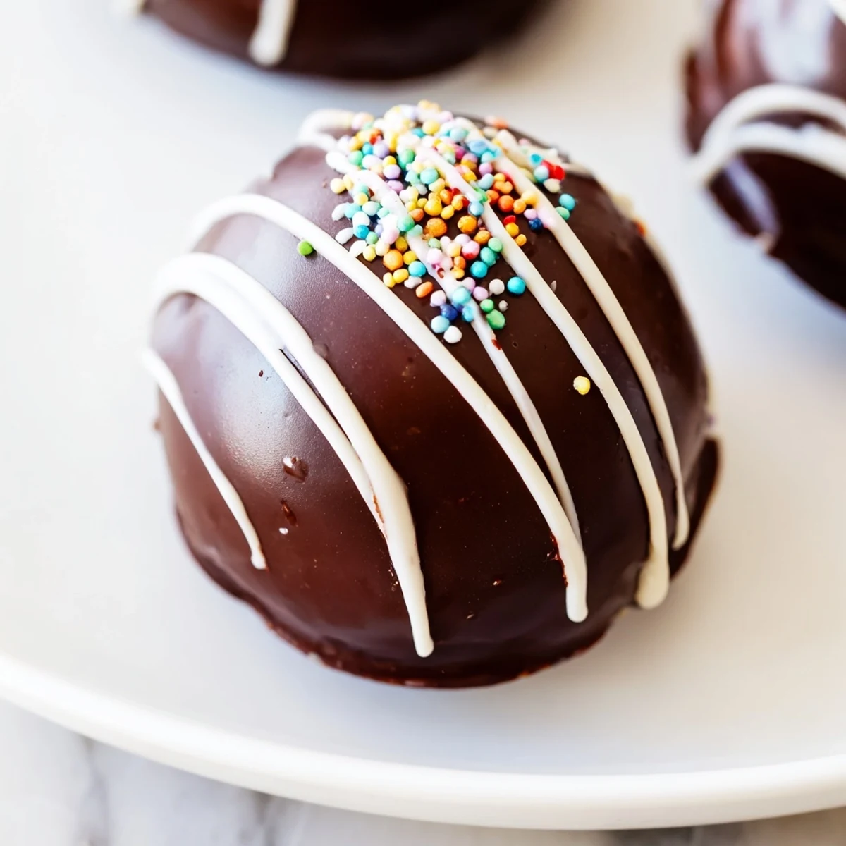 A mug brimming with creamy, dissolving Hot Chocolate Bombs, topped with colorful sprinkles.
