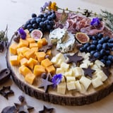 A beautifully arranged Celestial Night Board, overflowing with cheeses, charcuterie, and fresh fruits.