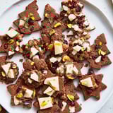 Festive Christmas Joy Trios arranged on a platter offer gingerbread cookies, bark, and warm mini tartlets.