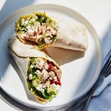 A close-up of a Greek Lemon Chicken Salad Wrap, filled with marinated chicken and vibrant Mediterranean salad ingredients.