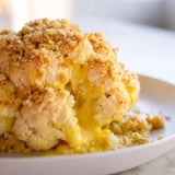 Tender wedges of Cheesy Stuffed Cauliflower Head served from a rustic baking tray, perfect as a vegetarian main or side.
