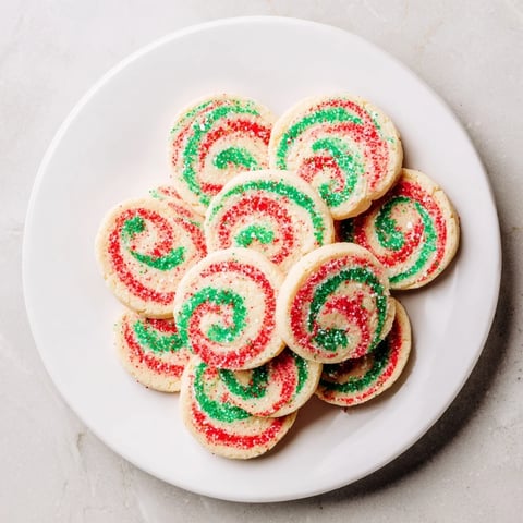 Festive Holiday Pinwheel Cookies, swirled with red and green, offering a delicious buttery flavor for the holidays.