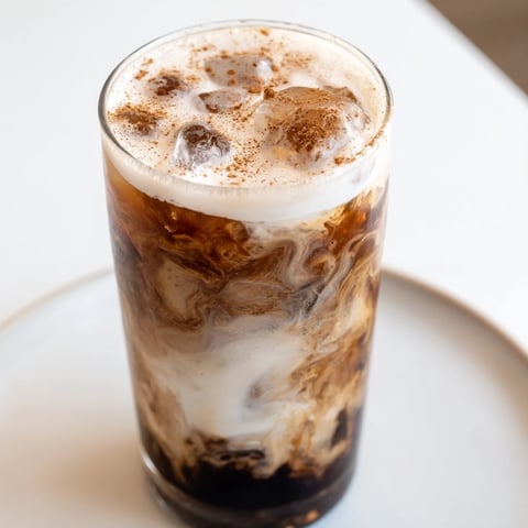 Frothy Iced Brown Sugar Oat Latte, a creamy vegan coffee drink shaken with ice and espresso.
