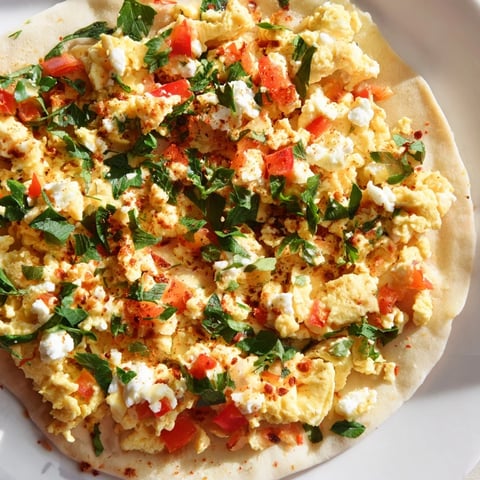 Golden, bubbly Turkish Menemen Eggs Pizza, with a vibrant topping, ready to slice and enjoy.