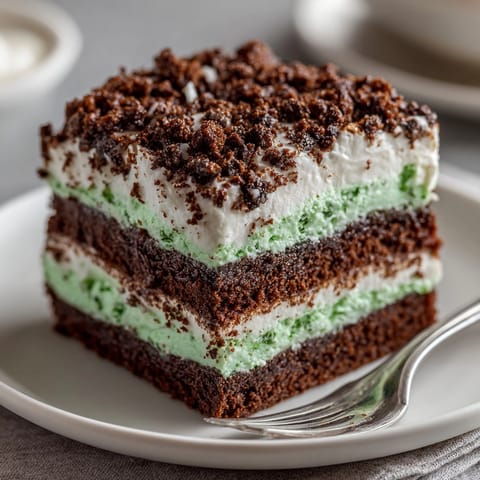 These sweet, decadent-looking Chaos Cake Peppermint Cookie Crumble Squares feature a lovely peppermint cream filling.