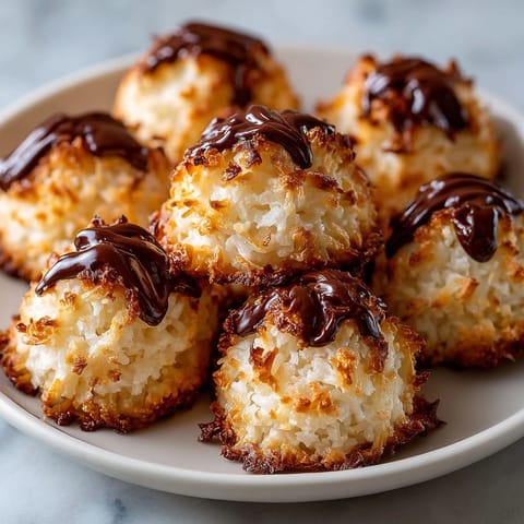 Close-up of perfectly baked Coconut Macaroon Cookies, showcasing crispy edges and a chewy texture.