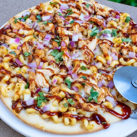 Homemade Mac and Cheese BBQ Chicken Pizza sizzling hot, ready for a cheesy dinner.