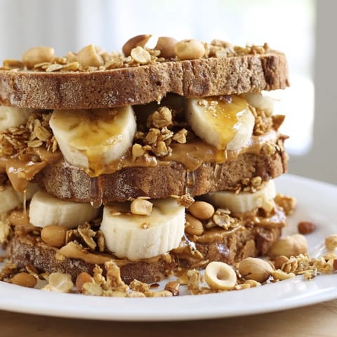 Warm, toasted peanut butter & banana sandwich, drizzled with honey, boasting a perfect texture combination.