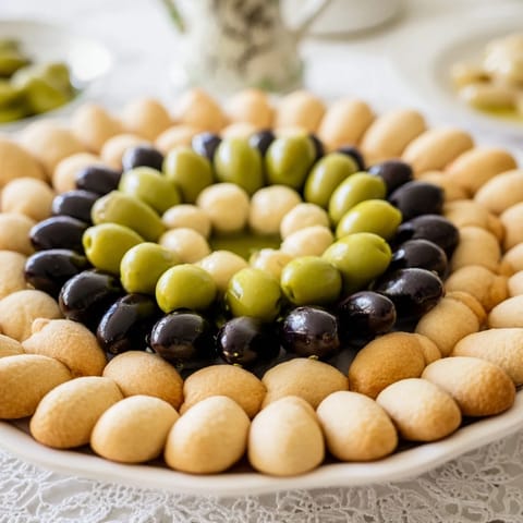 A tempting aerial shot of The Roman Colosseum Snack Platter with crackers arranged like a famous landmark.