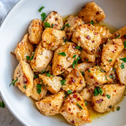 A close-up of delicious Garlic Butter Chicken Bites, swimming in a rich, flavorful garlic sauce.