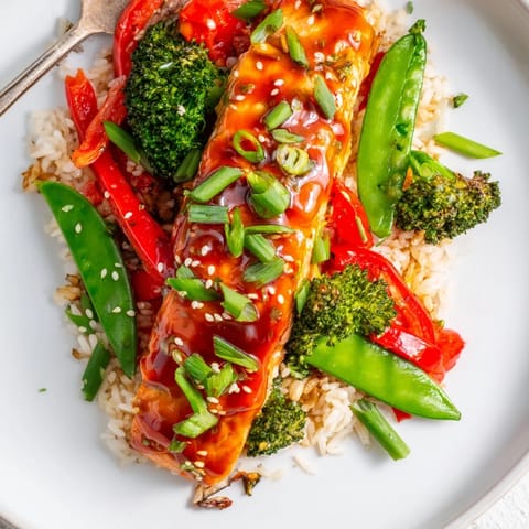 Bright, steaming bowls of maple soy glazed salmon served over jasmine rice and colorful vegetables, perfect for a quick and healthy weeknight meal.