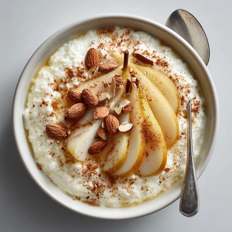 Velvety Sweet Ricotta with Fresh Fruit served chilled, garnished with juicy pear slices for freshness.