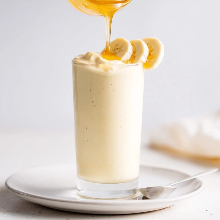 Making a delicious Healthy Banana Smoothie: bananas, yogurt, and milk blended for a simple breakfast.