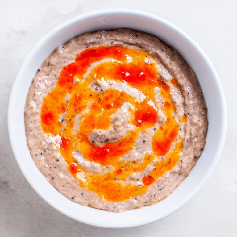 Vibrant photo shows a bowl of spicy black bean dip, a flavorful and easy Mexican appetizer.