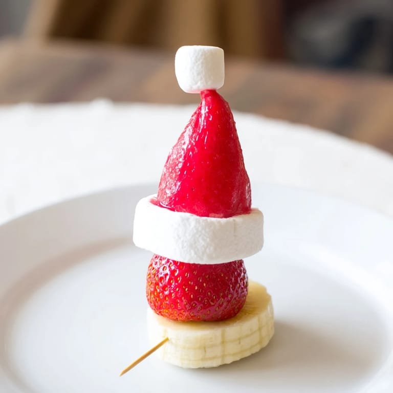 Kid-friendly, colorful Strawberry Banana Santa Sticks, presented beautifully on a platter for a holiday treat.
