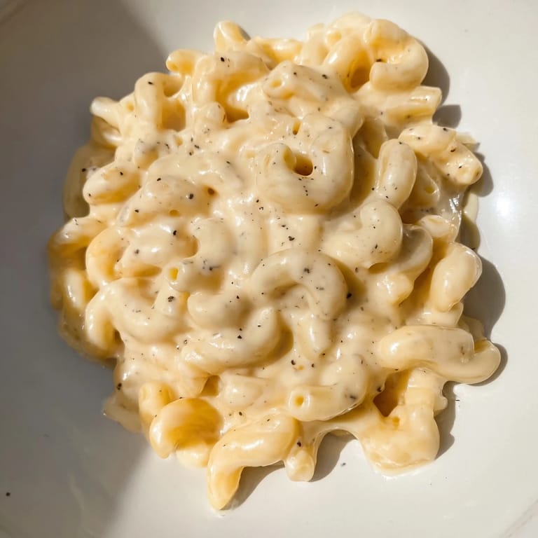 Golden-baked mac and cheese with a crispy breadcrumb topping, perfect for a cozy dinner.