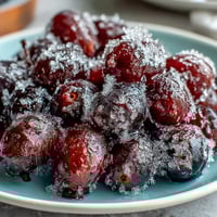 Frozen grape skewers with lime sugar, a refreshing summer snack bursting with juicy, sweet-tart flavor.